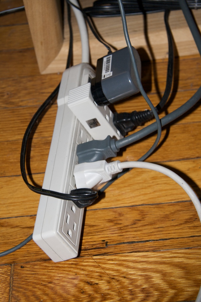 Another observation I made and attempted to solve was the tangled surge protector. This is a result of light and rigid plastic power strips, causing difficulties in organization.